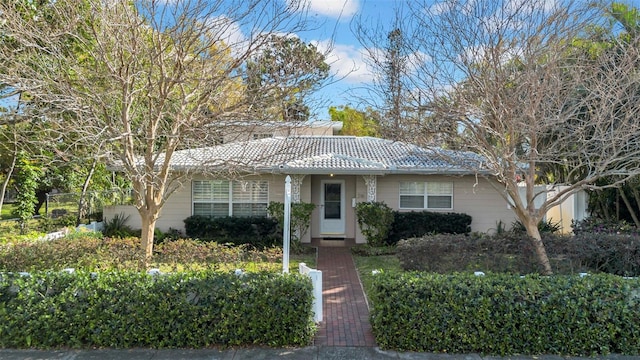 single story home featuring a tiled roof