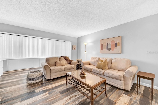 living room featuring dark hardwood / wood-style flooring and a textured ceiling