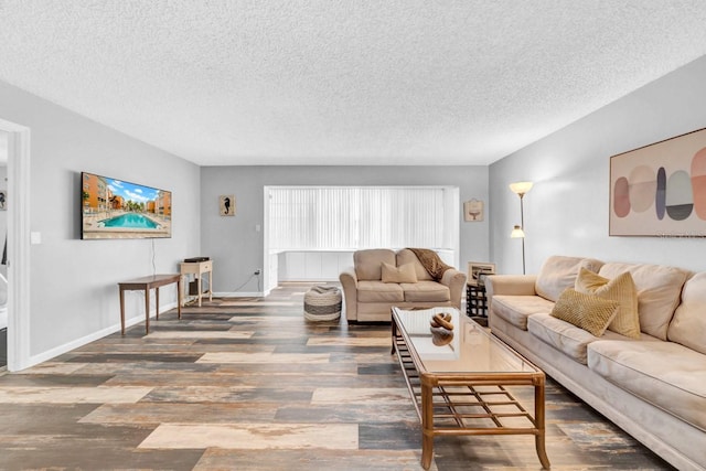 living room with hardwood / wood-style flooring and a textured ceiling