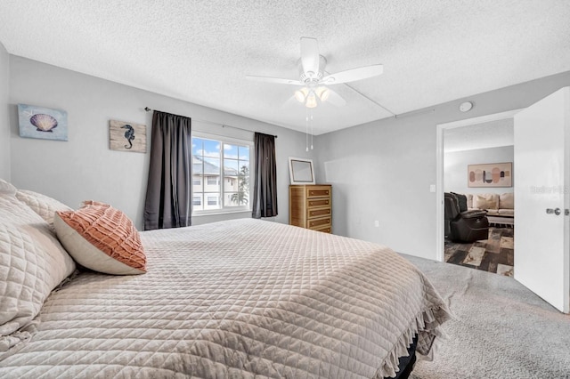 bedroom with ceiling fan and a textured ceiling