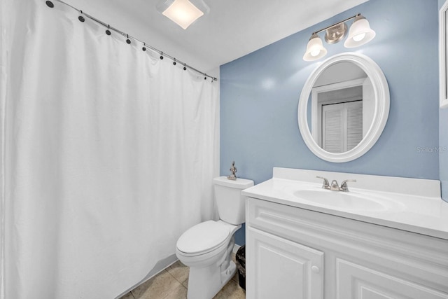 bathroom with vanity, toilet, and tile patterned flooring