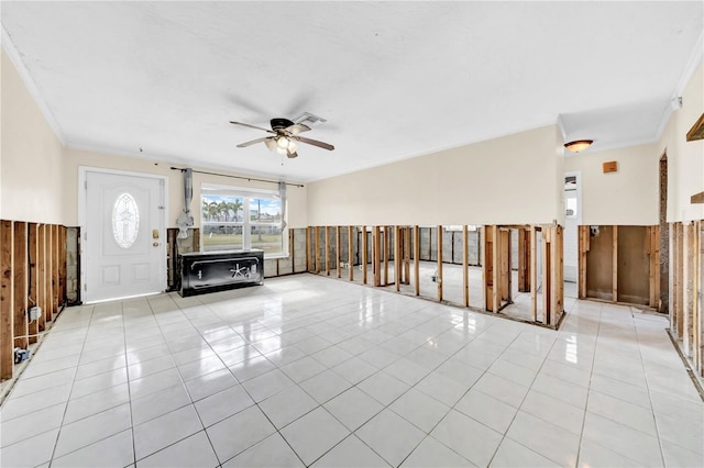 unfurnished living room featuring light tile patterned flooring, ceiling fan, and ornamental molding