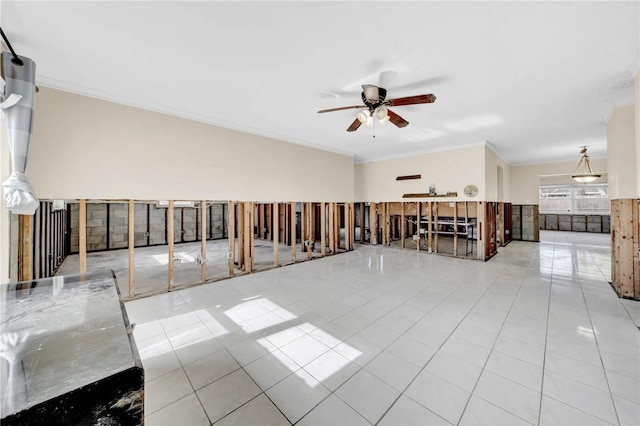 spare room with crown molding, light tile patterned floors, and ceiling fan