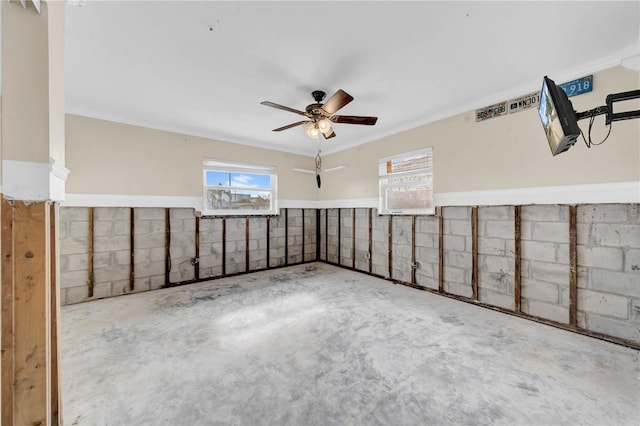 basement with crown molding and ceiling fan