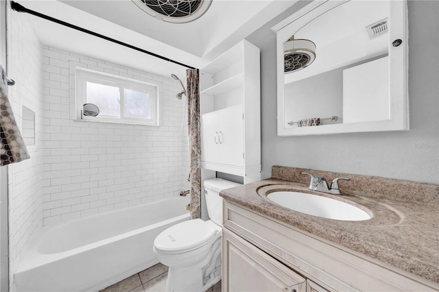 full bathroom featuring tiled shower / bath, vanity, toilet, and tile patterned flooring