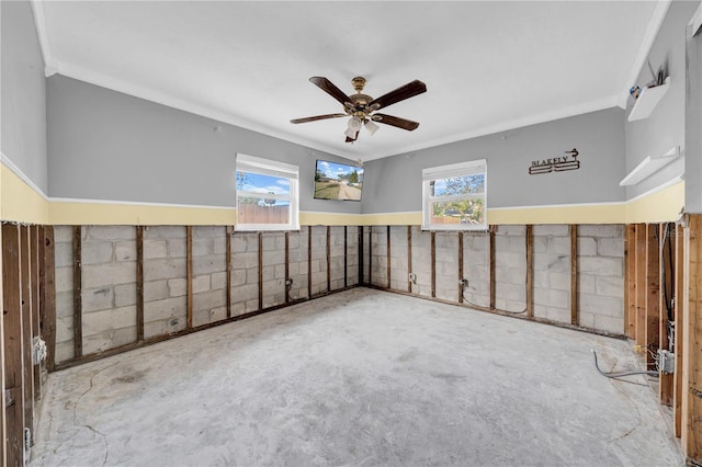 unfurnished room featuring ceiling fan, ornamental molding, and concrete floors