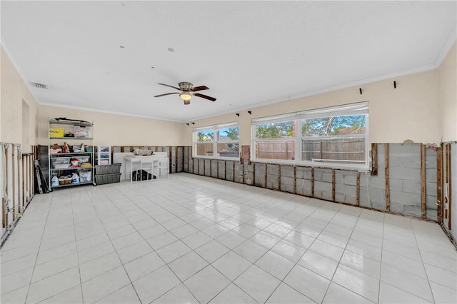 unfurnished living room featuring light tile patterned floors, crown molding, and ceiling fan