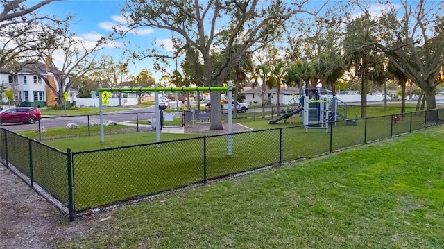 view of home's community featuring a lawn and a playground