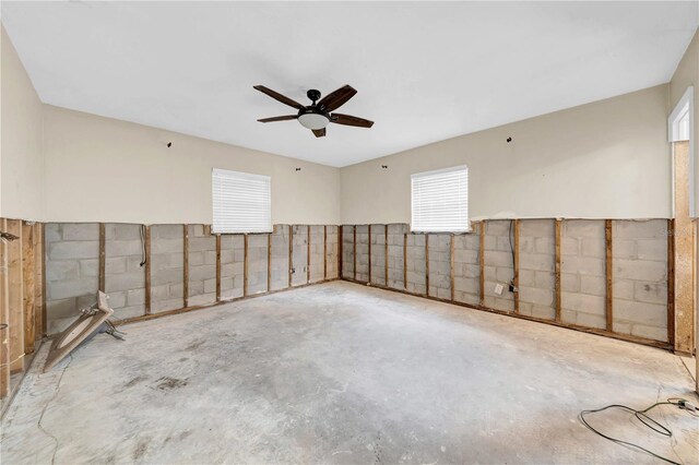 empty room with concrete flooring and ceiling fan