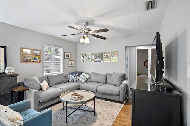 living room with hardwood / wood-style flooring and ceiling fan