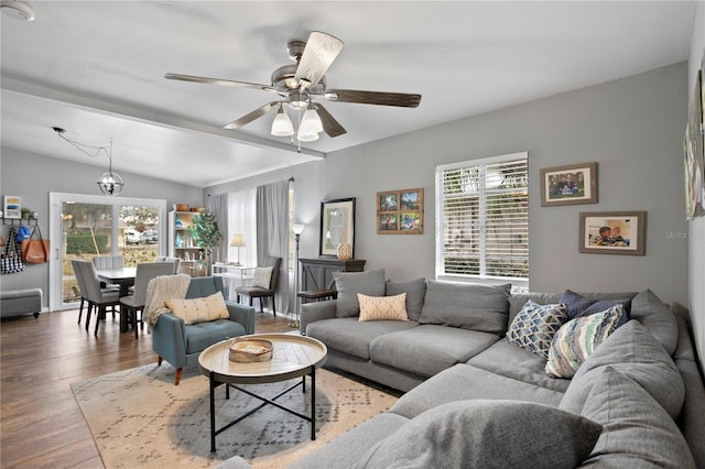 living room with ceiling fan, lofted ceiling, and wood-type flooring