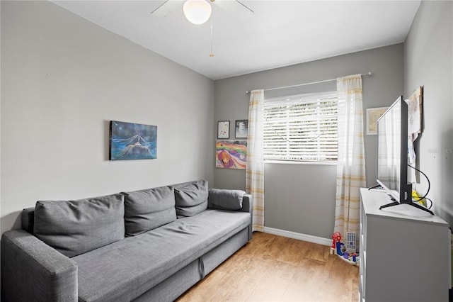 living room with ceiling fan and light wood-type flooring