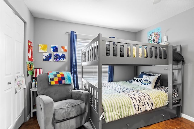 bedroom with dark tile patterned flooring