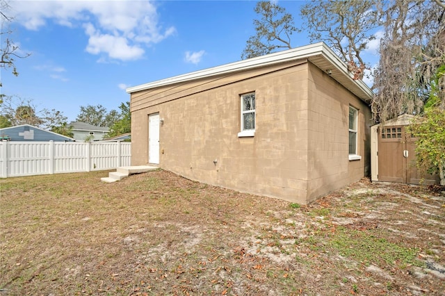 back of house with a lawn