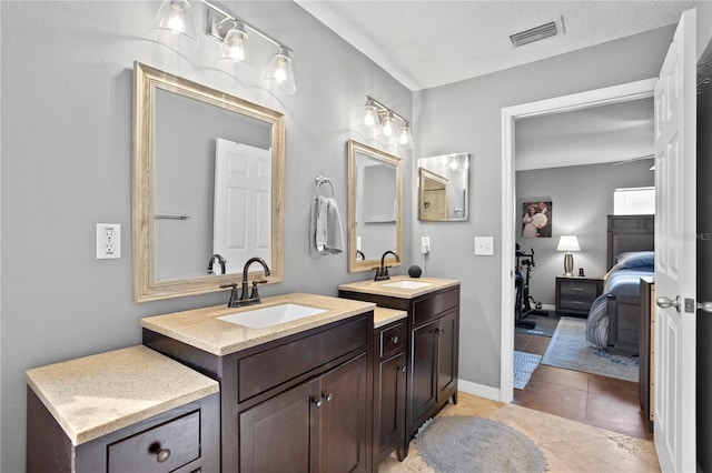 bathroom featuring tile patterned flooring and vanity