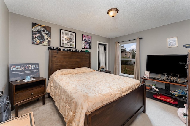 carpeted bedroom featuring a textured ceiling