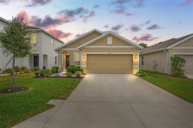 view of front facade featuring a garage and a lawn