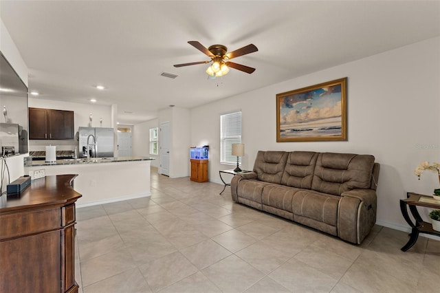 living room featuring ceiling fan and light tile patterned flooring