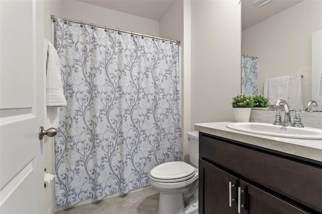 bathroom featuring tile patterned floors, toilet, and vanity