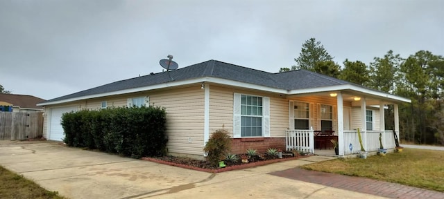 view of front facade with a porch and a garage