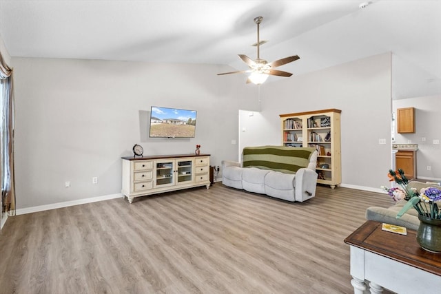 living room with lofted ceiling, light hardwood / wood-style flooring, and ceiling fan