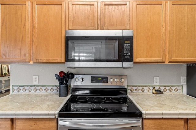 kitchen with stainless steel appliances and tile counters