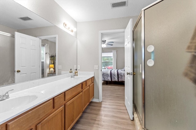 bathroom featuring vanity, hardwood / wood-style flooring, and walk in shower