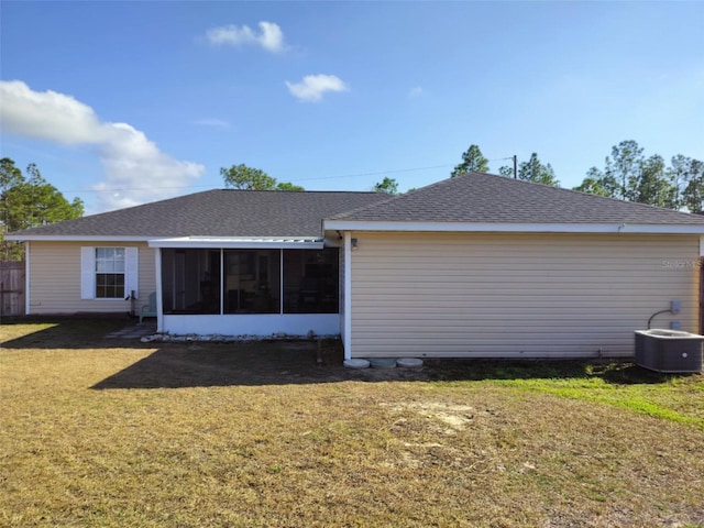 back of property featuring a yard, central AC unit, and a sunroom