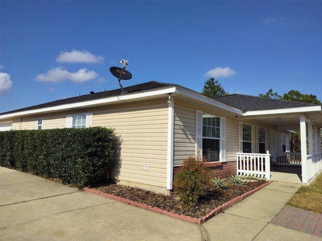 view of side of home with a porch