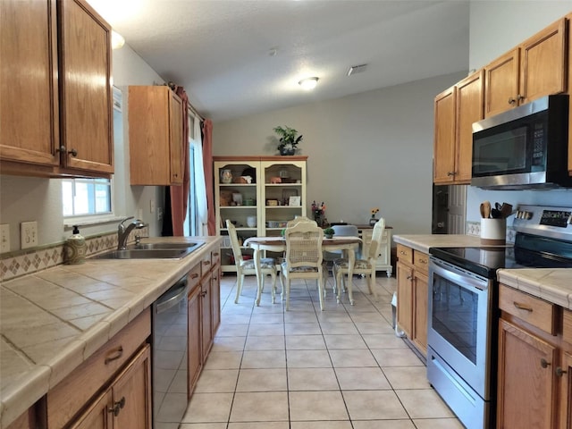 20 Hemlock Trl, Ocala, FL 34472 - kitchen with visible vents, light tile patterned floors, a sink, appliances with stainless steel finishes, and tile counters