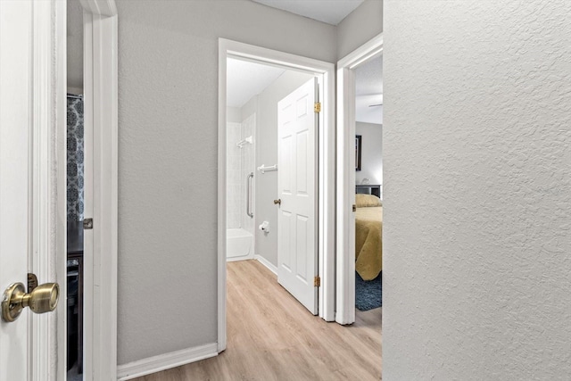 20 Hemlock Trl, Ocala, FL 34472 - corridor featuring a textured wall, baseboards, and wood finished floors
