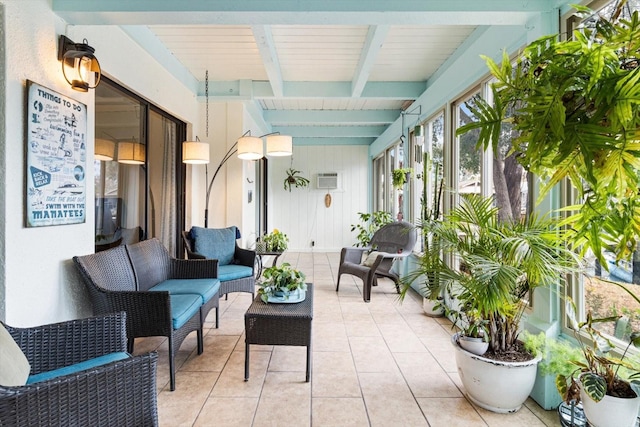 sunroom / solarium featuring beamed ceiling
