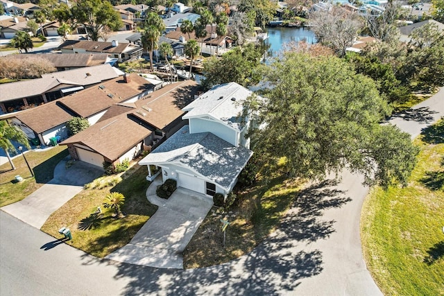 aerial view of residential area featuring a large body of water