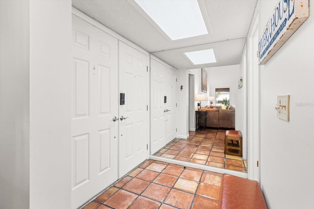 hall featuring a skylight and heating unit
