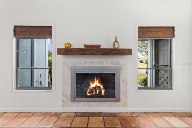 detailed view of baseboards and a high end fireplace