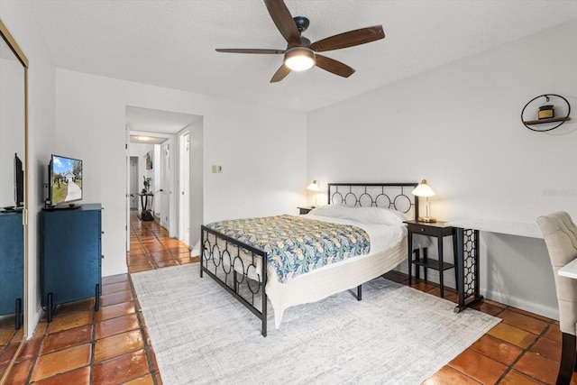 tiled bedroom featuring a closet and ceiling fan