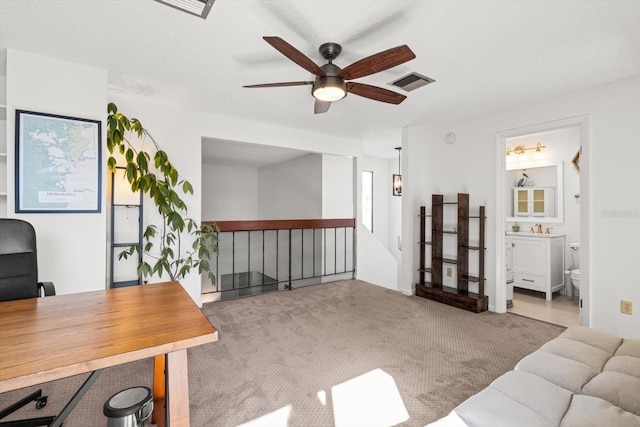 home office with a ceiling fan and carpet flooring