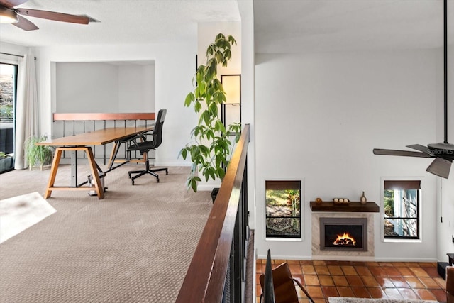 balcony featuring a ceiling fan and a premium fireplace