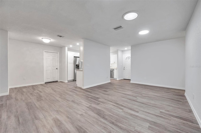 unfurnished living room featuring light wood-type flooring