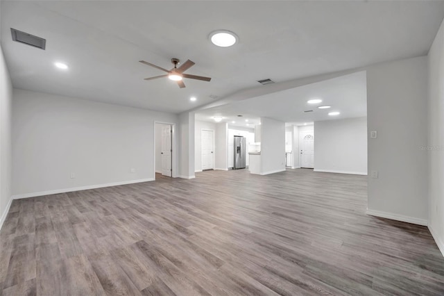 unfurnished living room featuring ceiling fan and hardwood / wood-style floors