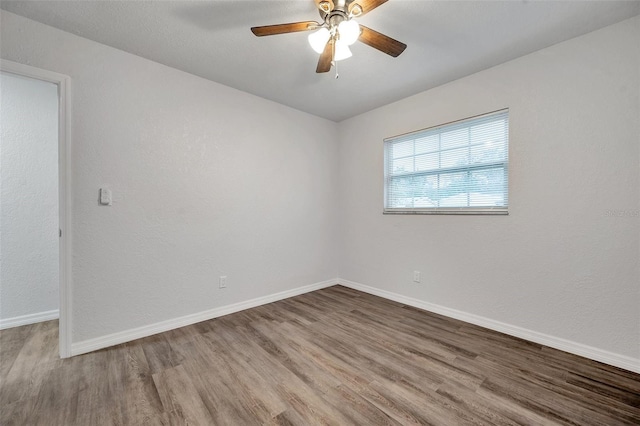 empty room featuring hardwood / wood-style flooring and ceiling fan