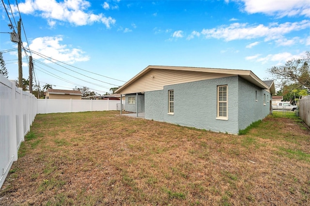 back of property with a lawn