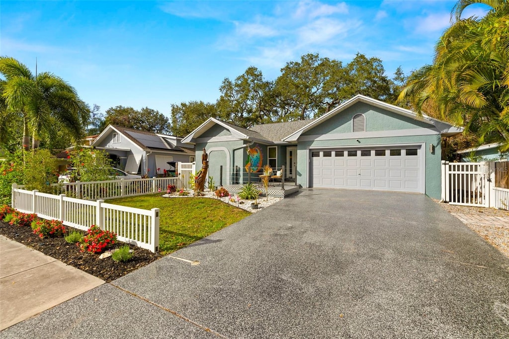 ranch-style house featuring a garage and a front yard