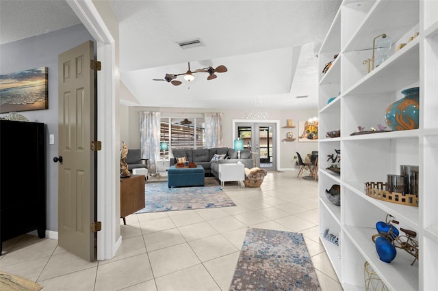 interior space featuring a textured ceiling, french doors, and light tile patterned flooring