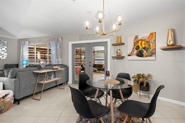 tiled dining room with vaulted ceiling, french doors, a healthy amount of sunlight, and an inviting chandelier