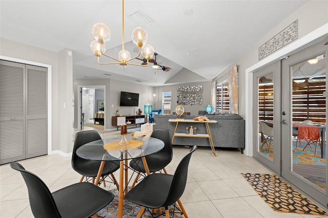 dining space featuring light tile patterned floors, an inviting chandelier, french doors, and vaulted ceiling