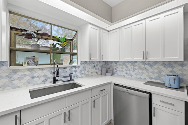 kitchen with sink, white cabinetry, and stainless steel dishwasher