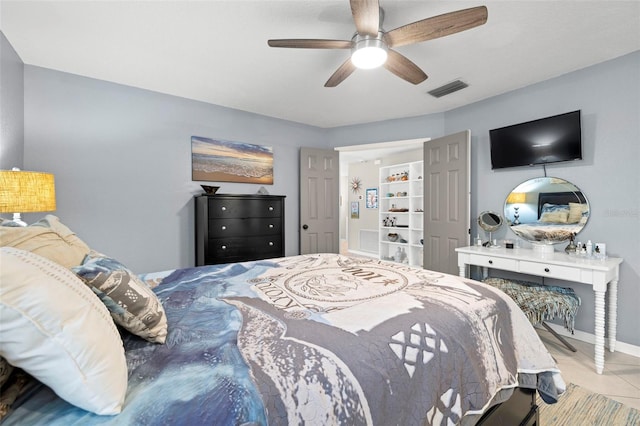 tiled bedroom featuring ceiling fan