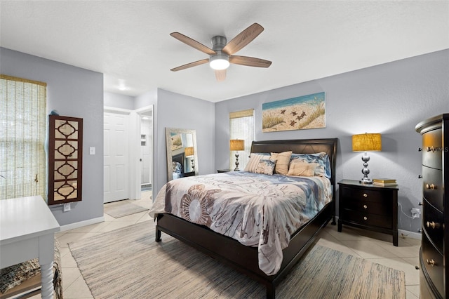 bedroom with light tile patterned flooring and ceiling fan