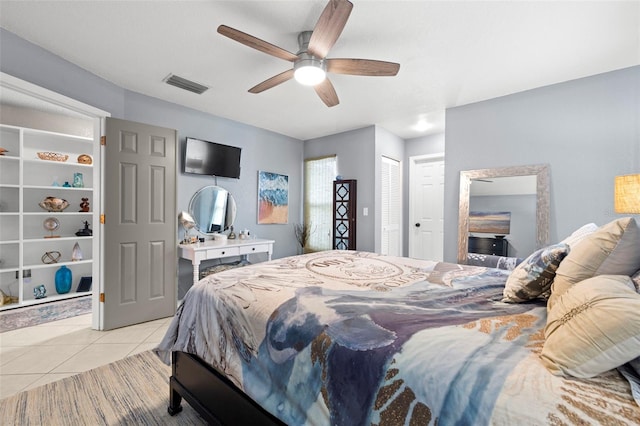 tiled bedroom with a closet and ceiling fan